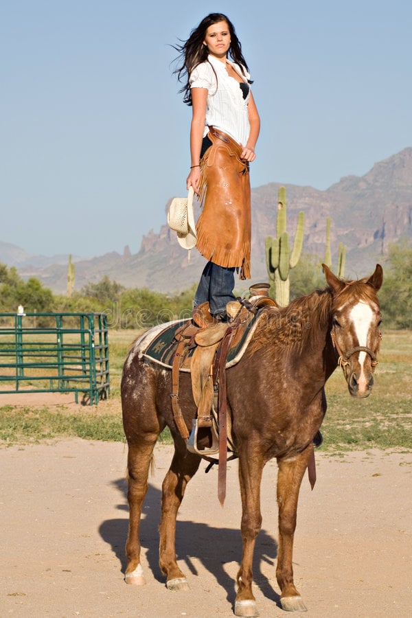 Woman standing on her horse