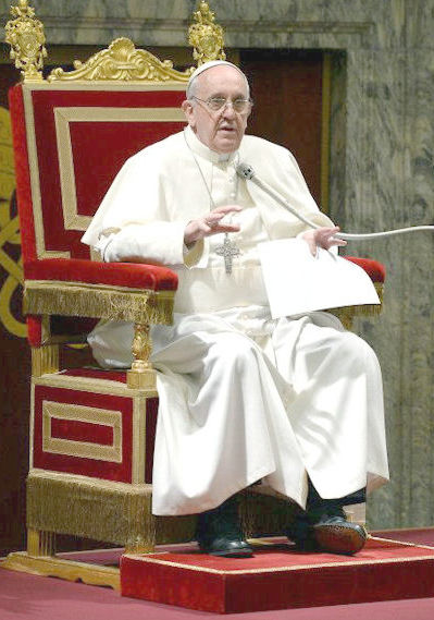 Pope Francis wearing black trousers under his white robe.